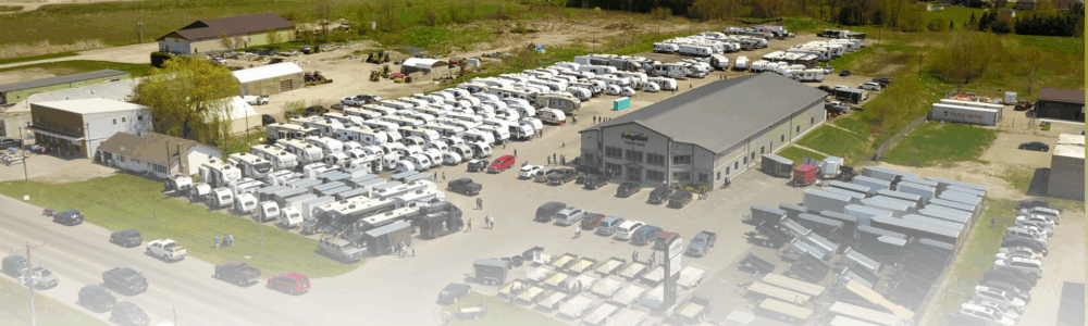A picture of Long Haul Trailer Sales dealership. You can see a yard full of used and new rv's and trailers ready for sale. You can see the service and parts department from this ariel view.